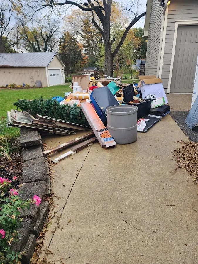 Dumpster being loaded with debris for Commercial Dumpster Rental in Hamilton